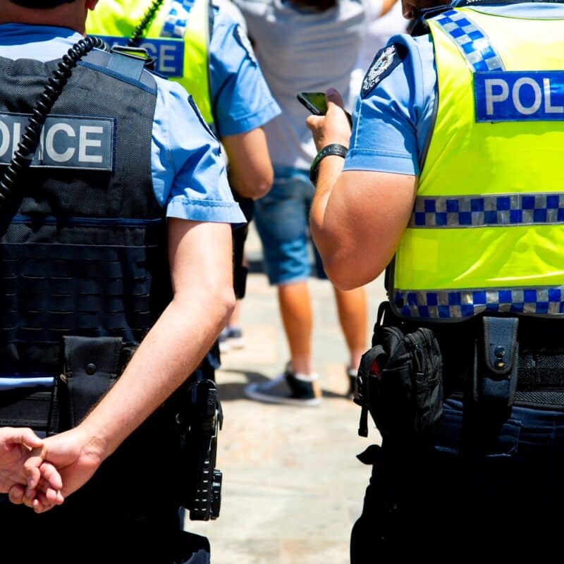 cropped image of 2 police officers in a crowd