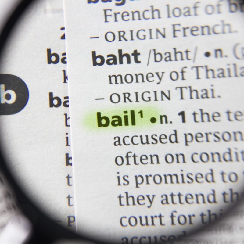 magnifying glass over the word bail in dictionary