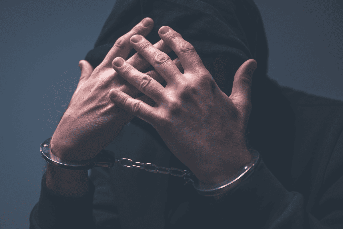 photo of a hoodies man in handcuffs 