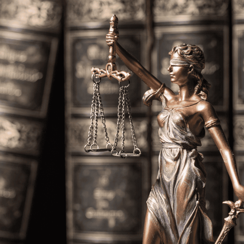 photo of legal of lady justice and books